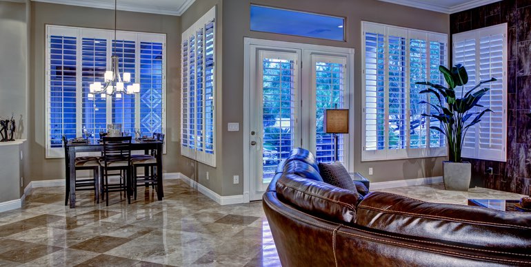 Houston great room with white shutters and leather furniture.